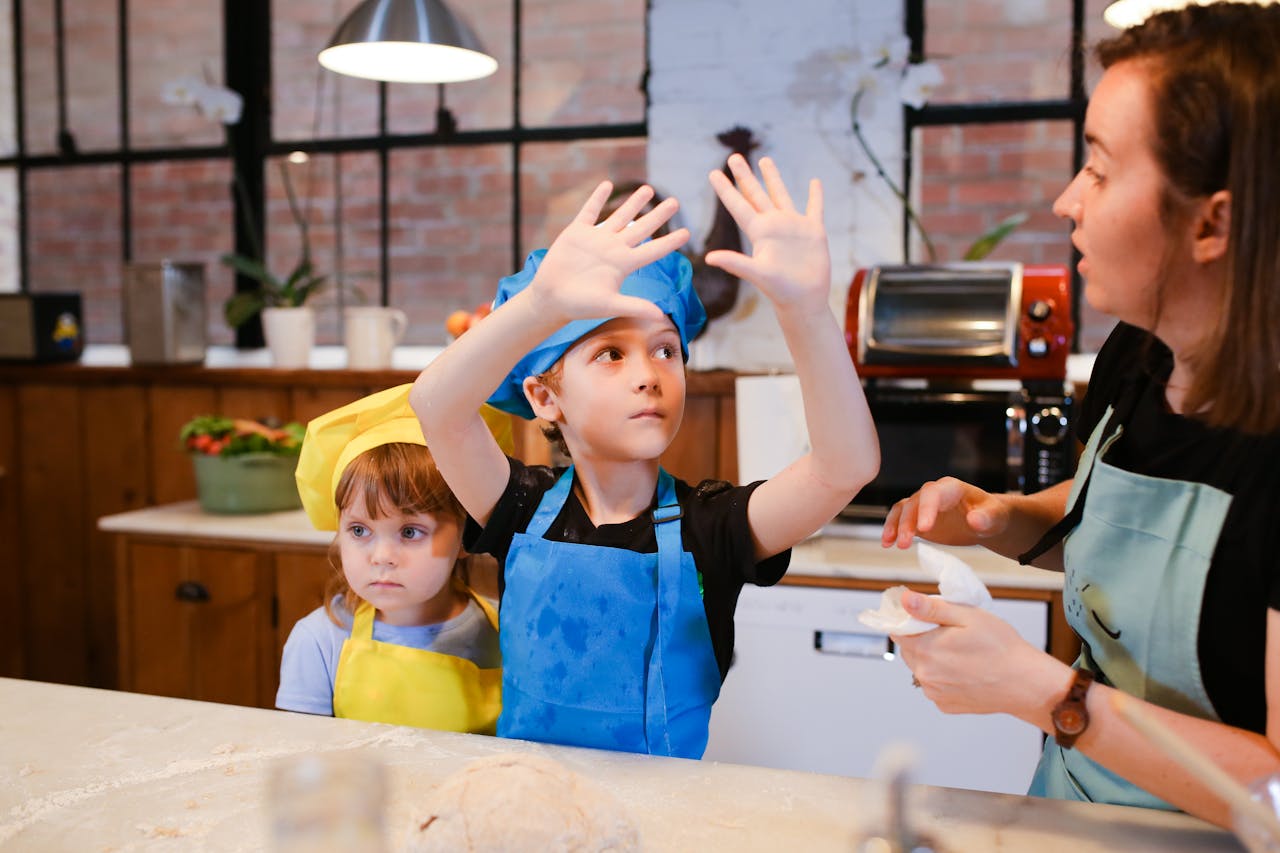 about-me Kids having fun in a baking class, learning to make cookies together with an instructor.