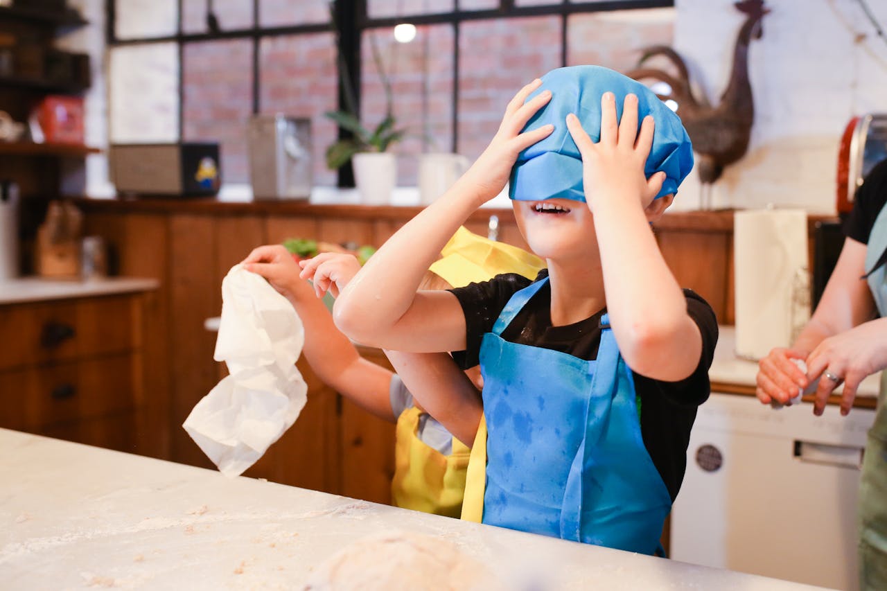 my-path Kids enjoy a playful cooking session in a cozy kitchen, learning and laughing.